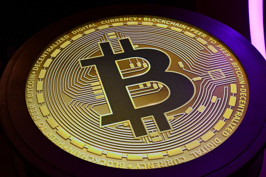 The Bitcoin logo is shown during the Token Conference.